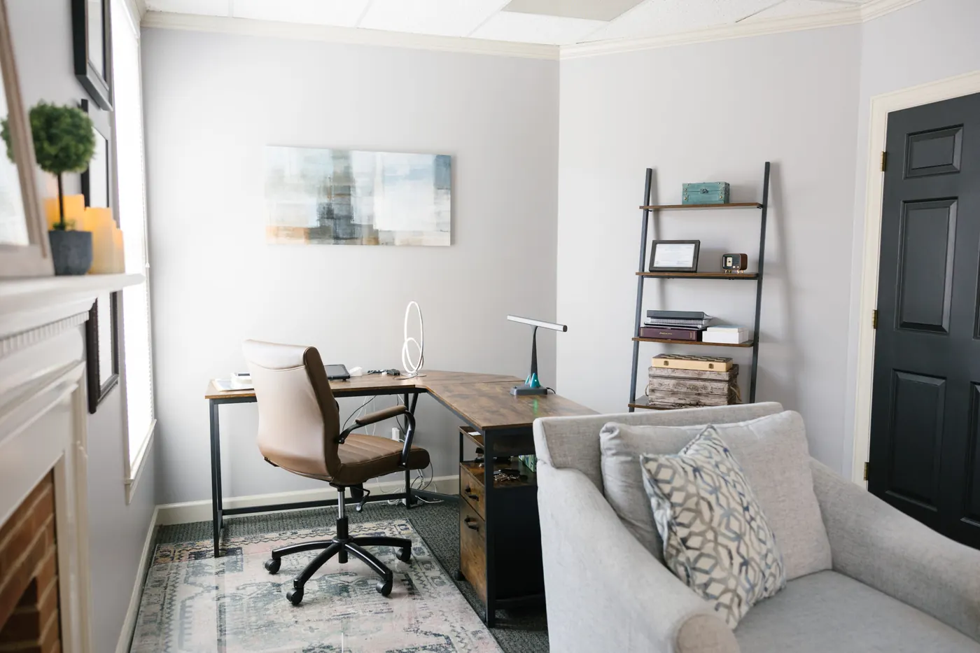 My desk, bookshelf and a sofa in a bright room